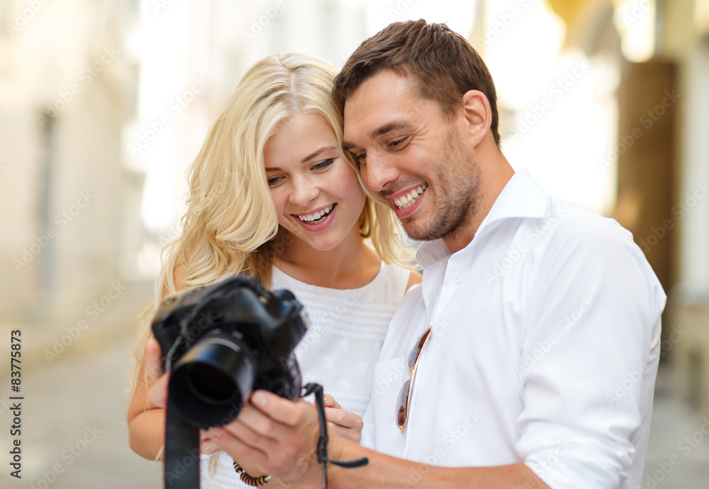 smiling couple with photo camera