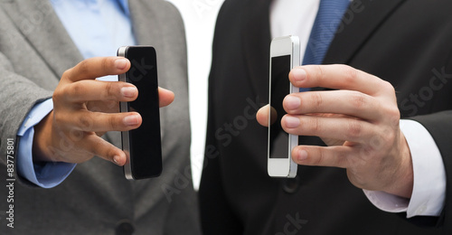 businessman and businesswoman with smartphones