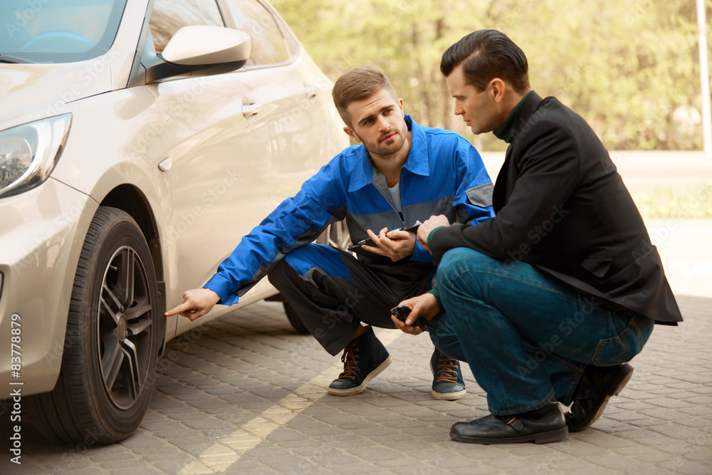 Mechanic and Customer Discussing Problem With Car. Mechanic and Customer Discussing Problem With Car.