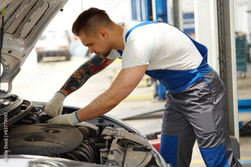 Closeup Portrait of Mechanic Servicing a Car at His Workshop