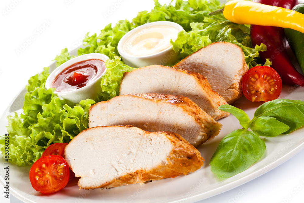 Roast chicken fillet and vegetables on white background Roast chicken fillet and vegetables on white background
