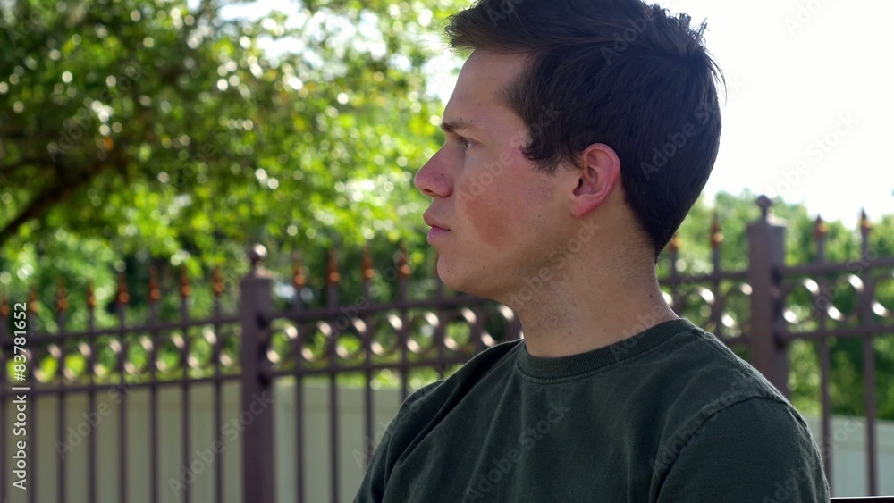 Young man smiles sitting on bench, CLOSE, 4K Young man smiles sitting on bench, CLOSE, 4K