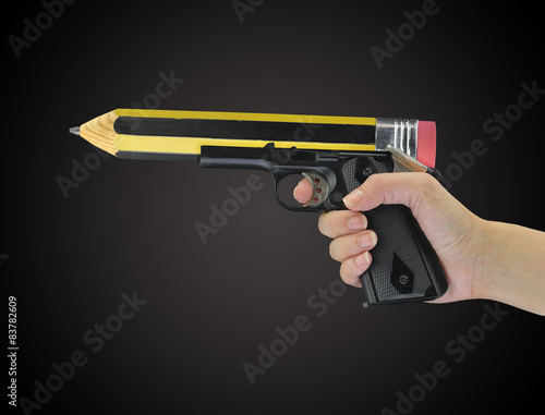 Fotografie Hand holding gun with pencil point isolated on black