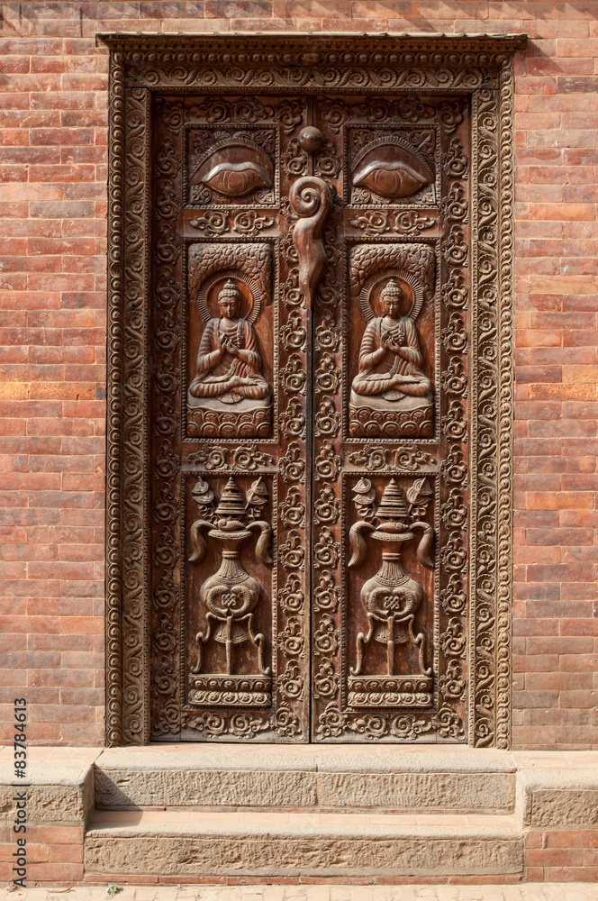 Old carved wooden door in Nepal. National art of curving
