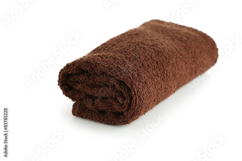 Rolled up brown towel isolated on white