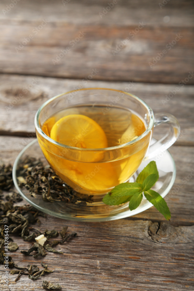 Cup with green tea on grey wooden background Cup with green tea on grey wooden background