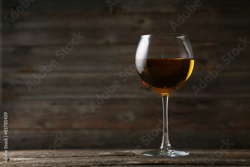 White wine glass on grey wooden background