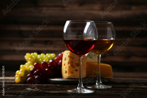 Glass of red wine  cheeses and grapes 
