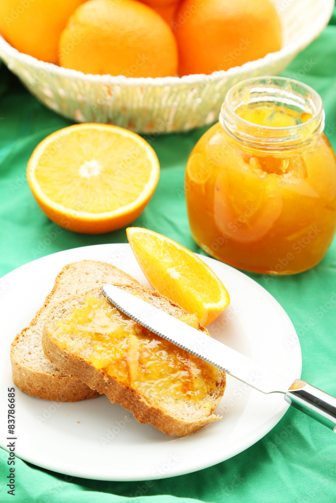 Orange juice in bottle and orange in basket Orange juice in bottle and orange in basket