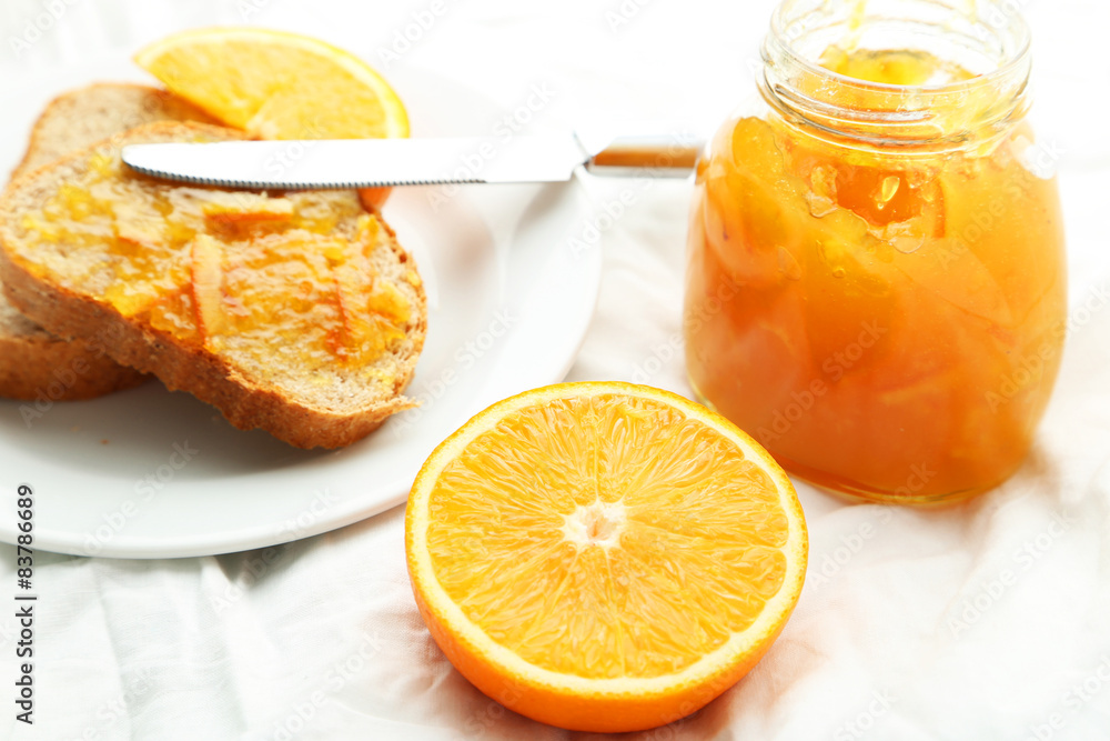 Orange juice in bottle and orange in basket Orange juice in bottle and orange in basket