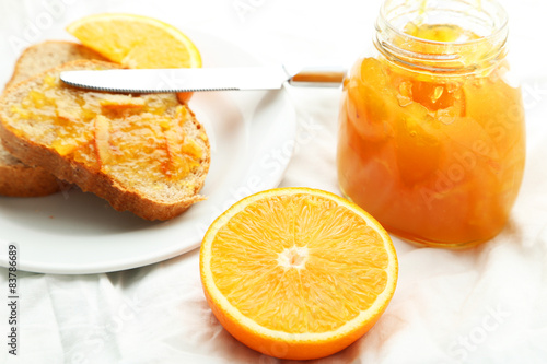 Orange juice in bottle and orange in basket 