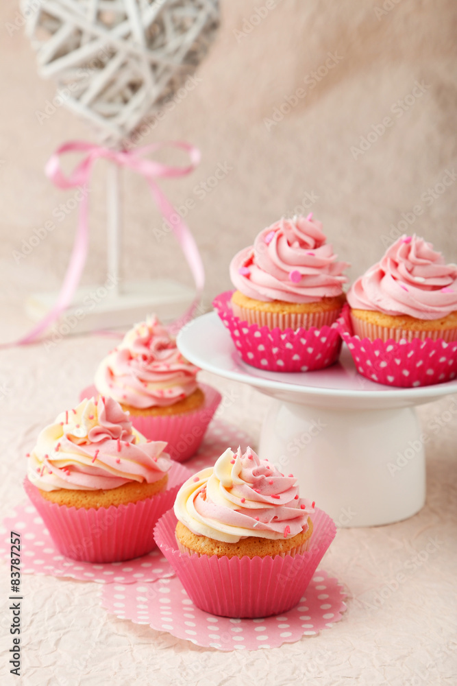 Tasty cupcake on pink background