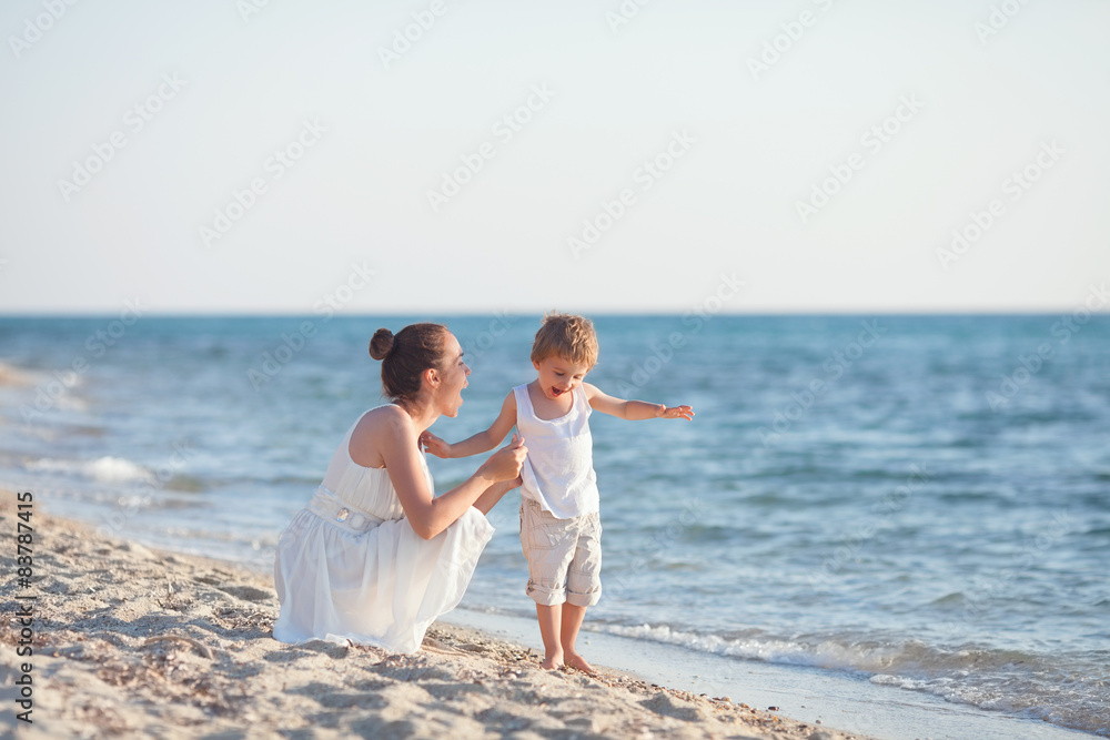 Playful young family having fun on the beach Playful young family having fun on the beach