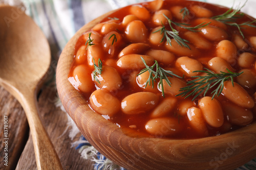 beans in tomato sauce in a wooden bowl, horizontal
