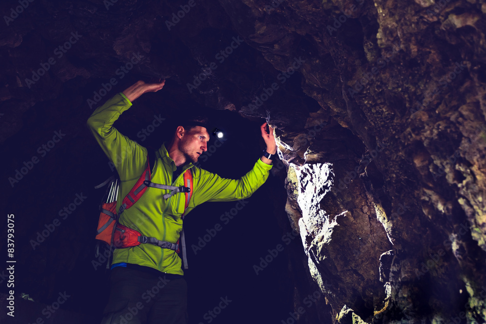 Man exploring underground dark cave tunnel Man exploring underground dark cave tunnel