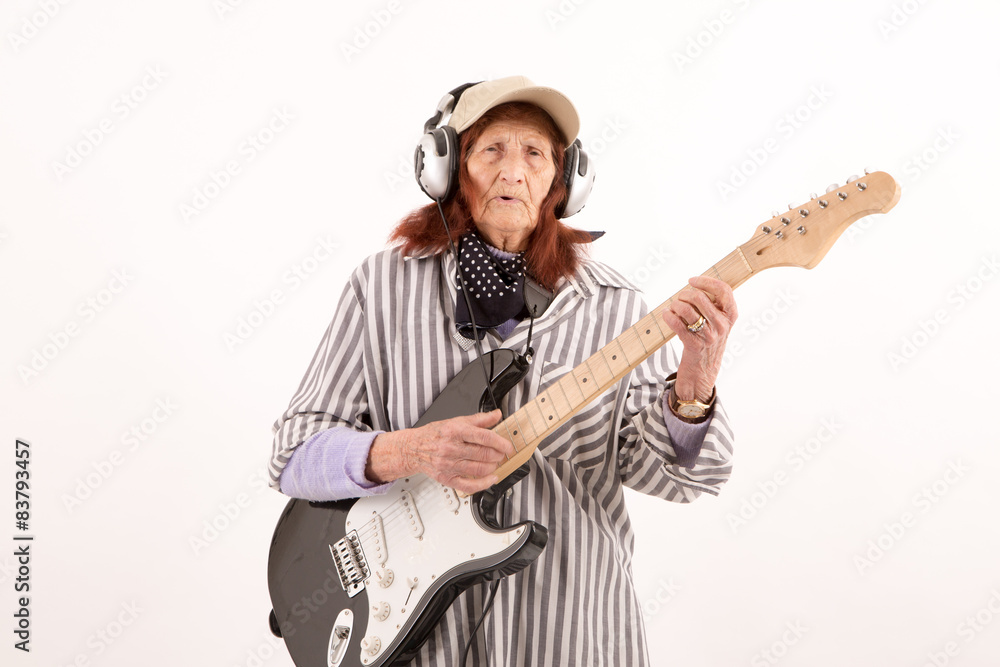 Funny elderly lady playing electric guitar. Funny elderly lady playing electric guitar.