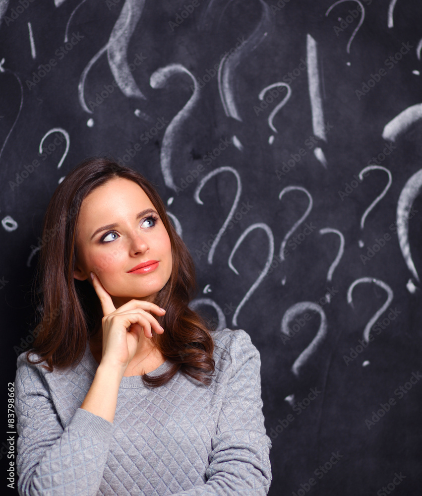 Young girl with question mark on a gray background Young girl with question mark on a gray background