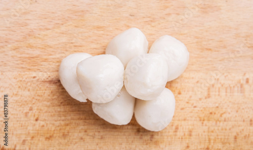 Canvas Print Raw white fish ball on a wooden surface