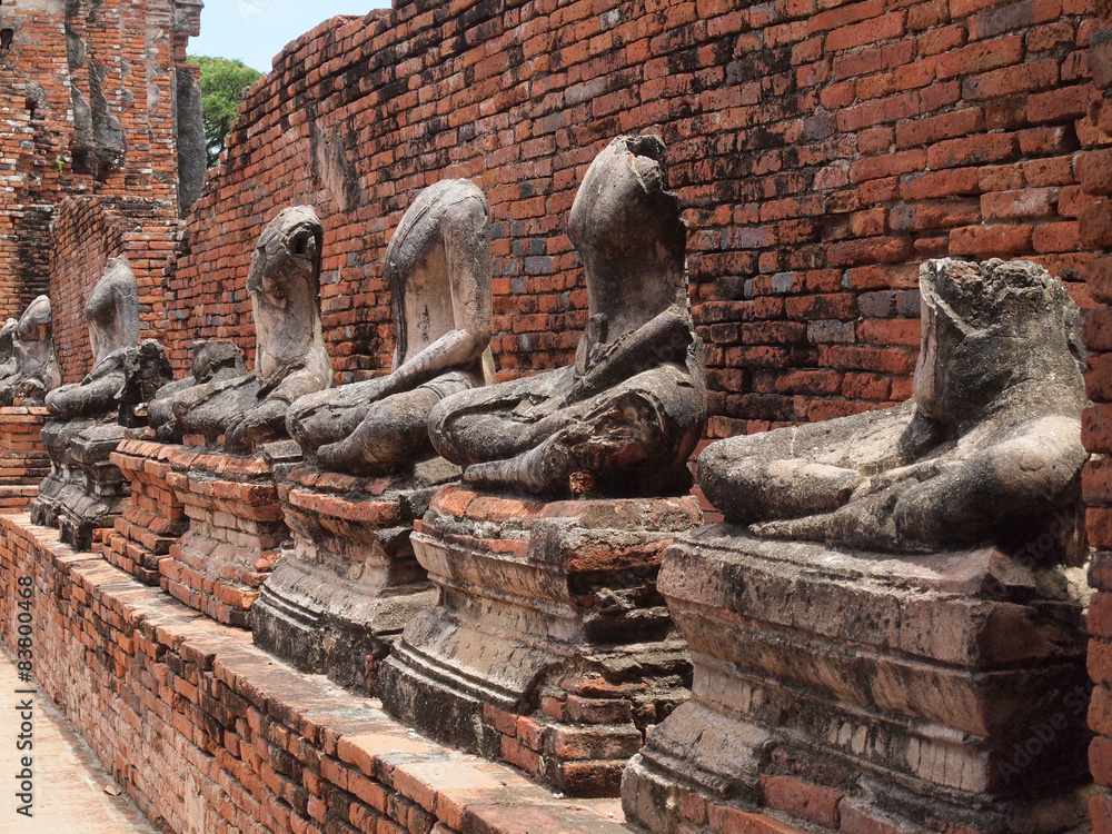 Buddha with old brick wall Ayutthaya, Thailand