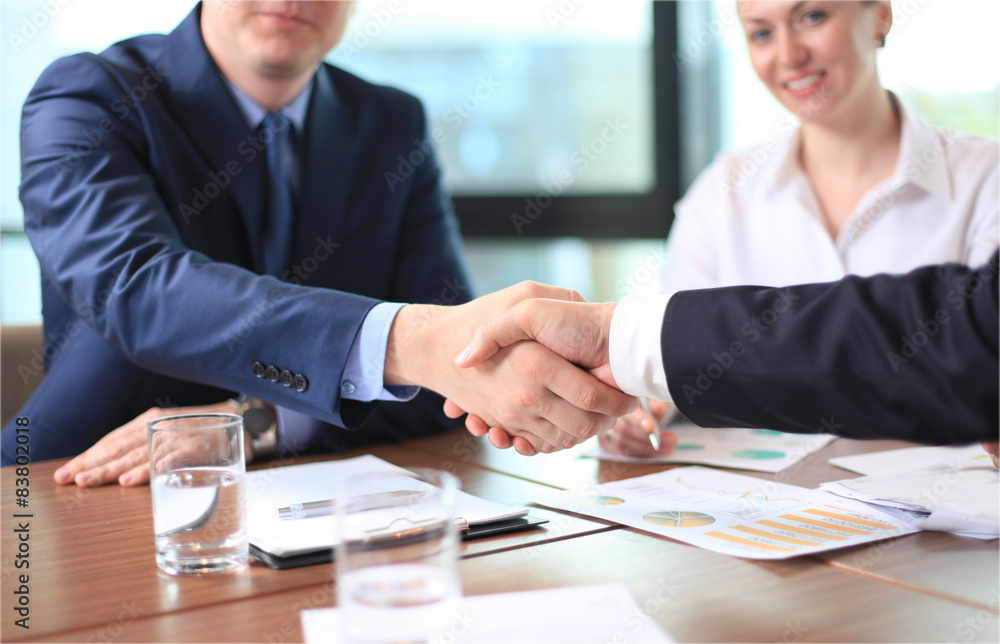 Business people shaking hands, finishing up a meeting Business people shaking hands, finishing up a meeting