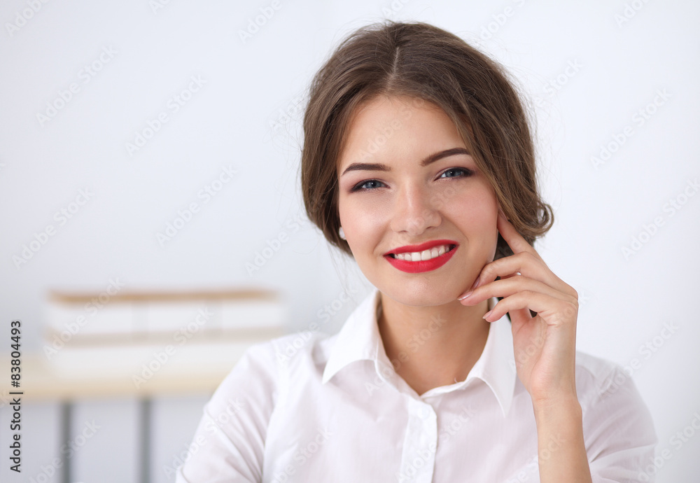 Attractive businesswoman sitting in the office Attractive businesswoman sitting in the office