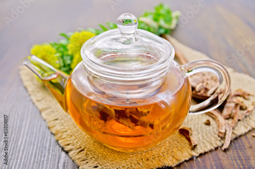 Tea of Rhodiola rosea in glass teapot on board