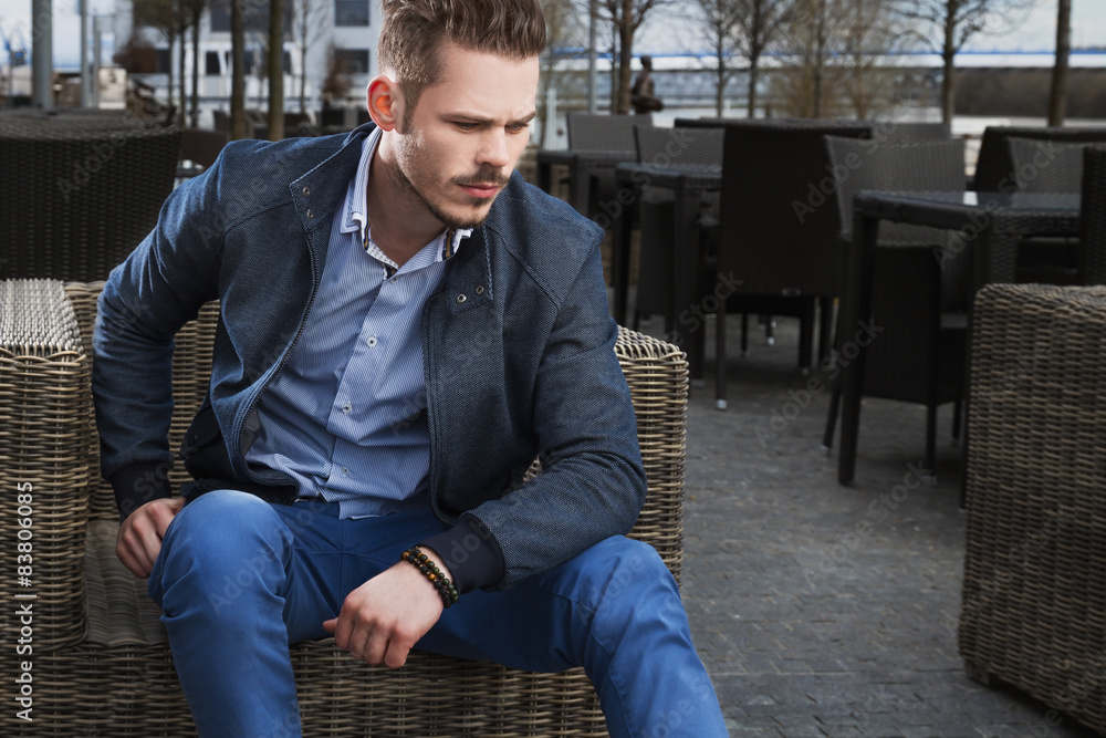 Man sitting on rattan chair