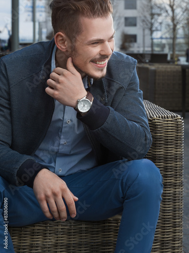Man sitting on rattan chair