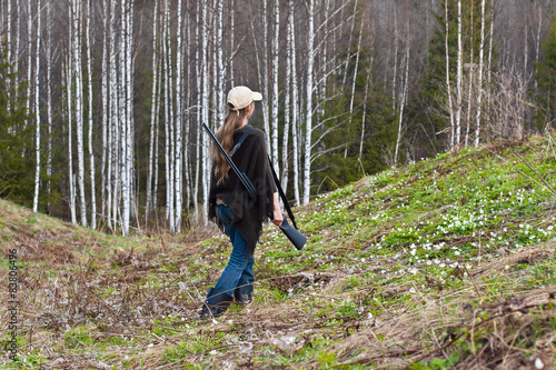 Woman hunter shooting on the forest edge © rodimovpavel