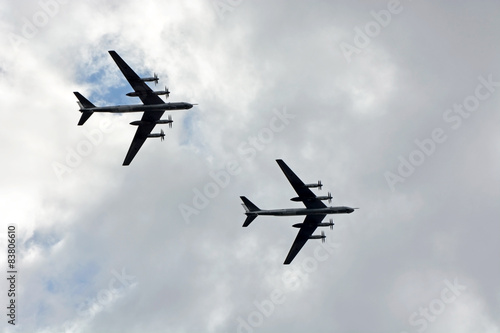 Military bomber against cloudy sky. Military scene