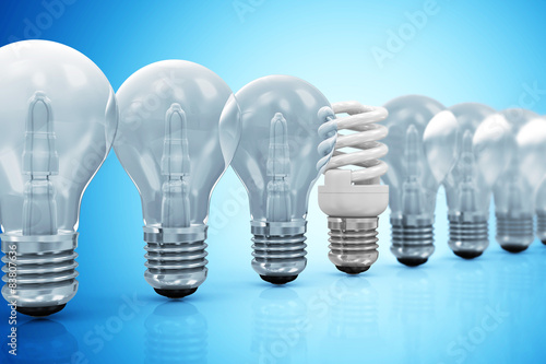 Modern Fluorescent Light Bulb standing out from the others Light Bulbs on blue gradient background