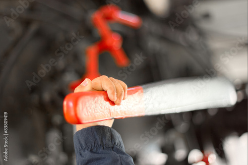 The hand of a child pulling a red lever in the cab of an old steam locomotive FS940, imagining conductor photo