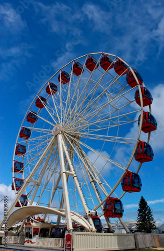 Ferris wheel at amusement park against blue sky