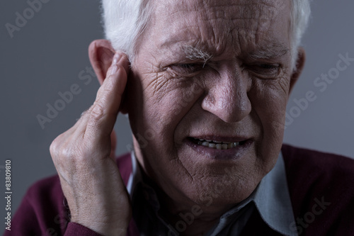 Old man with tinnitus photo