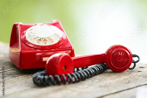 Red phone on wooden deck