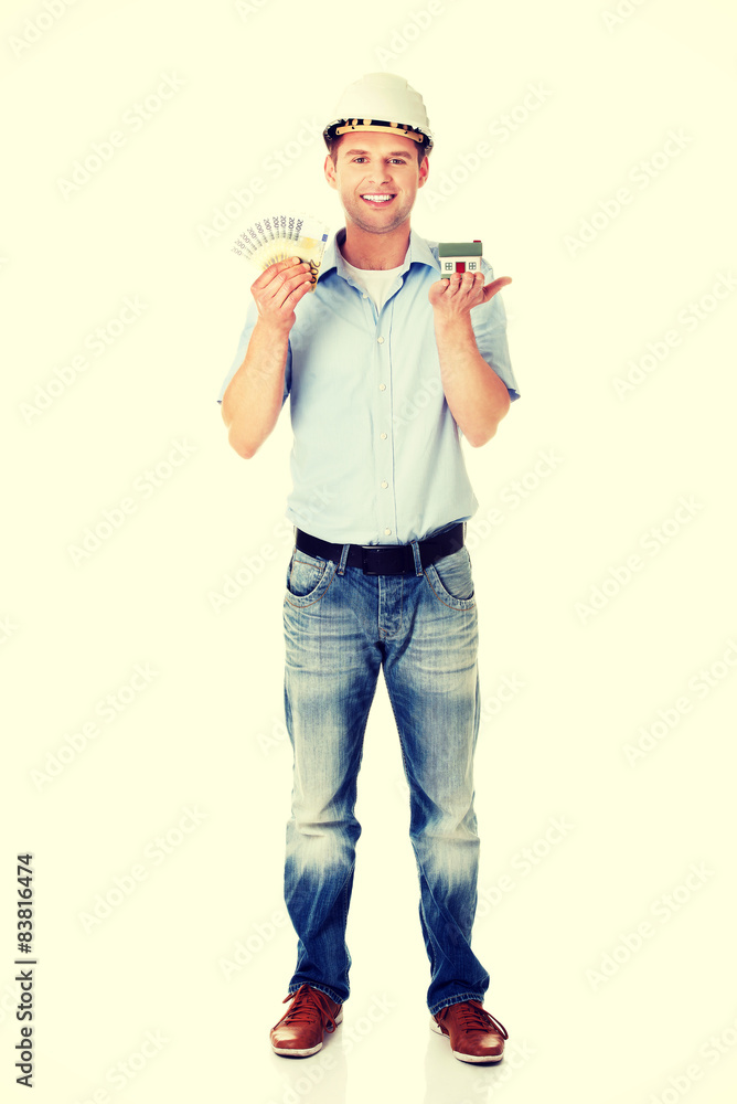 Construction man holding house model and money Construction man holding house model and money