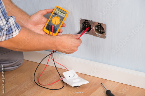 Person Hand Checking Socket Voltage