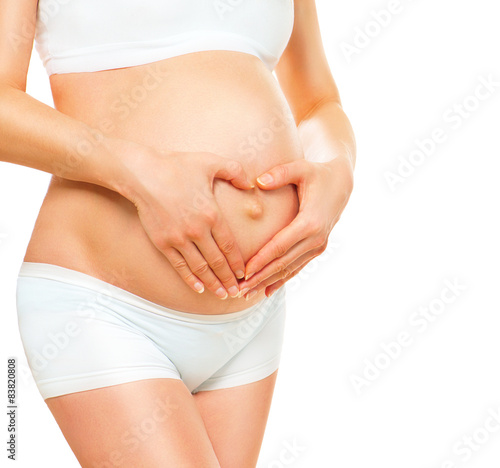 Pregnant woman holding her hands on her baby bump