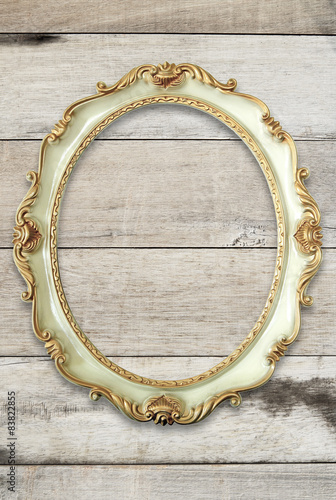 Vintage golden frame on wooden background