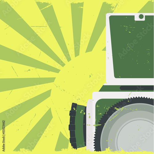 Old-fashioned photocamera on grunge background