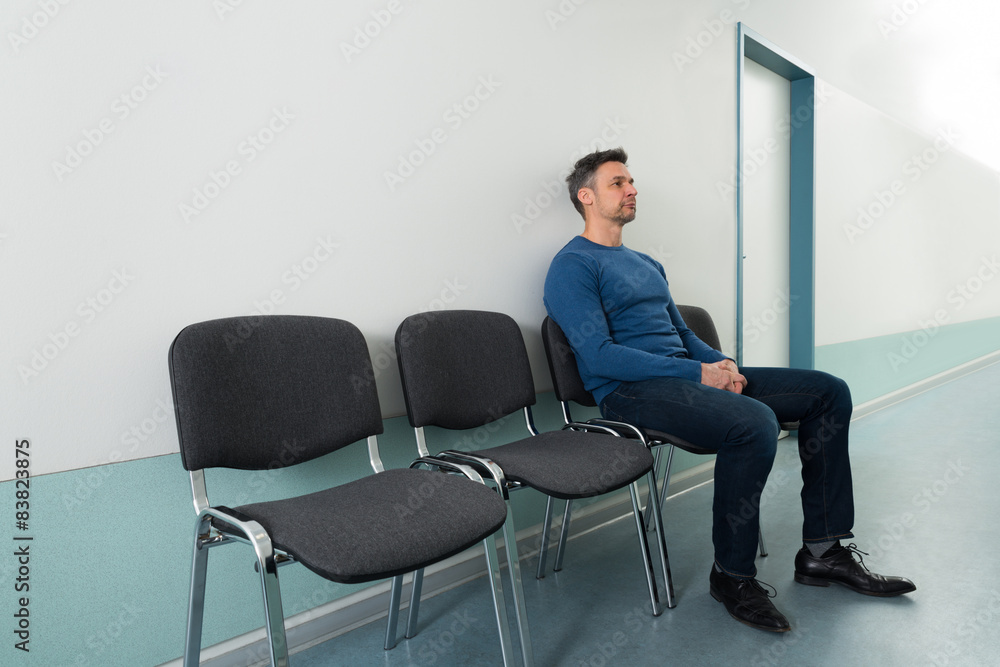 Man Sitting On Chair In Hospital Man Sitting On Chair In Hospital
