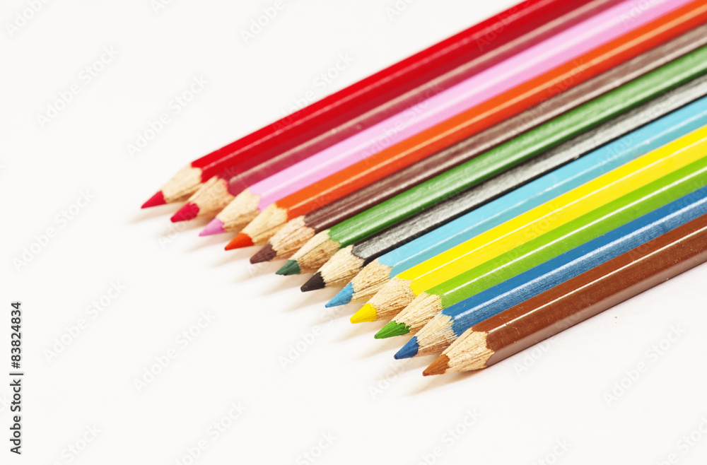 Colored pencils on white background, selective focus Colored pencils on white background, selective focus