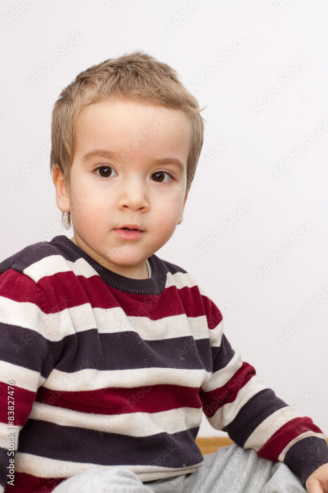 Portrait of cute little boy sitting on the floor Portrait of cute little boy sitting on the floor