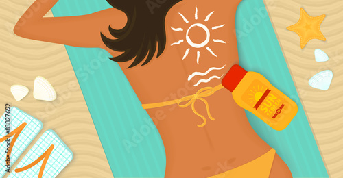 Young girl sunbathes on a beach