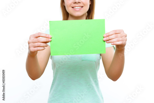 Smiling girl holding green sheet of paper