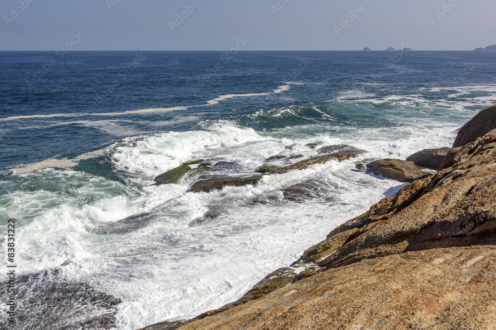 Waves breaking over rocks