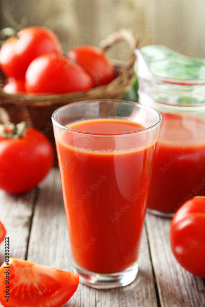 Fresh red tomatos in basket and juice in glass Fresh red tomatos in basket and juice in glass