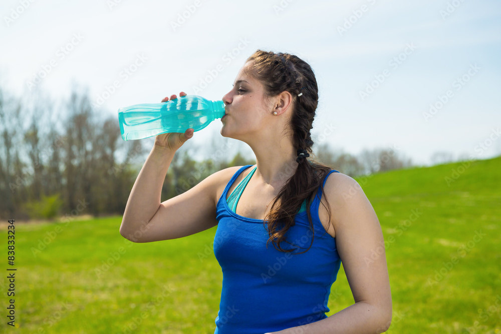Beautiful young woman drink water after fitness workout . Beautiful young woman drink water after fitness workout .
