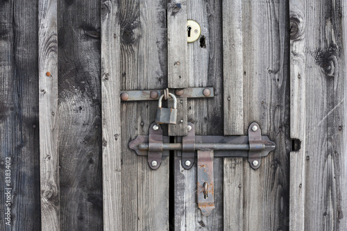 Fragment of wooden door with a key lock. 