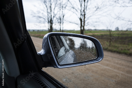 Wet by the rain the car mirror. © gashgeron